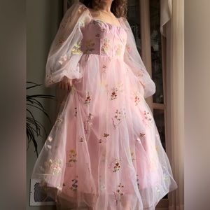 A beautiful flower embroidered pink tulle dress.